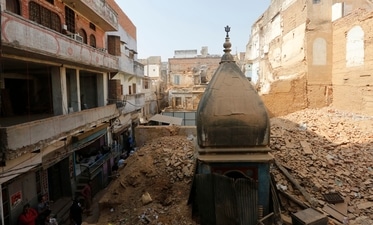 Demolition work is being carried out for the Kashi Vishwanath Temple Corridor which aims to connect the Kashi Vishwanath temple in Varanasi and the river Ganga. The city of Varanasi is considered one of the oldest continuously inhabited cities in the world. (AP Photo) Demolition work is being carried out for the Kashi Vishwanath Temple Corridor which aims to connect the Kashi Vishwanath temple in Varanasi and the river Ganga. The city of Varanasi is considered one of the oldest continuously inhabited cities in the world. (AP Photo)