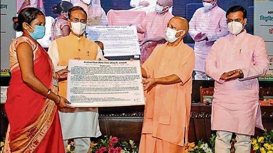 Uttar Pradesh chief minister Yogi Adityanath and deputy chief minister Dinesh Sharma distributing joining letters to assistant teachers under the Mission Rozgaar scheme at a function in Lucknow on Friday. (SOURCED )