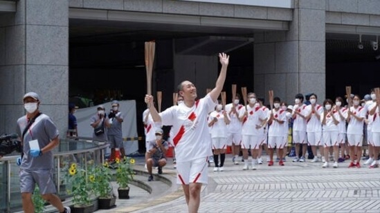 Kankuro Nakamura, a kabuki actor and the final torchbearer for the Tokyo Olympics, waves during the final torch relay event at the Tokyo Metropolitan Government complex in Tokyo Friday, July 23, 2021.(AP)