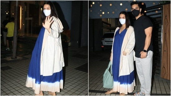 Neha's dress came with a plunging neckline and double straps. The dark blue attire featured the tie-dye detail on the hem in white and pink hues. The actor teamed her midi with a full-sleeve, blush pink hooded trench coat.(Varinder Chawla)