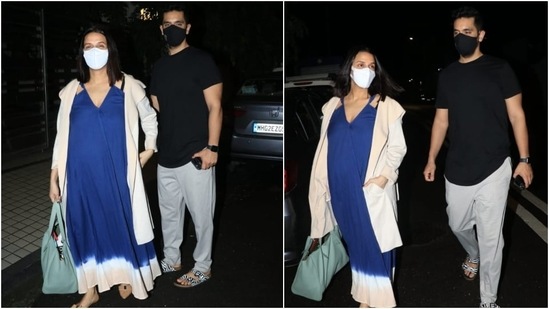 Neha carried a turquoise blue shoulder bag with her attire. She teamed her look with a white face mask, middle-parted open locks, and no accessories. Her pregnancy glow took things up a notch.(Varinder Chawla)