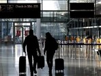 People walk through a deserted check-in hall at the airport in Munich, Germany.(Representational image/AP)