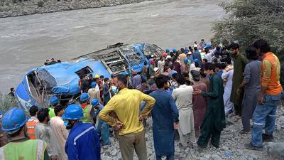 Rescue workers and onlookers gather around a wreck after a bus plunged into a ravine following a bomb explosion, which killed several passengers including nine Chinese nationals, in Kohistan district of Khyber Pakhtunkhwa province on July 14, 2021. (AFP) Rescue workers and onlookers gather around a wreck after a bus plunged into a ravine following a bomb explosion, which killed several passengers including nine Chinese nationals, in Kohistan district of Khyber Pakhtunkhwa province on July 14, 2021. (AFP)
