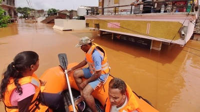 People stranded in flood waters watch others being rescued at Kolhapur in western Maharashtra (AP Photo) People stranded in flood waters watch others being rescued at Kolhapur in western Maharashtra (AP Photo)