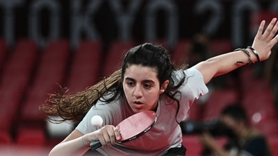 Syria's Hend Zaza hits a shot against Austria's Liu Jia during their women's singles preliminary round table tennis match at the Tokyo Metropolitan Gymnasium during the Tokyo 2020 Olympic Games in Tokyo on July 24, 2021. (AFP)