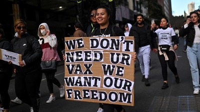 Most of the anti-lockdown protestors were seen walking maskless and were carrying signboards with slogans like "Wake up Australia" and "Drain the Swamp".. (Photo by Steven SAPHORE / AFP) (AFP) Most of the anti-lockdown protestors were seen walking maskless and were carrying signboards with slogans like "Wake up Australia" and "Drain the Swamp".. (Photo by Steven SAPHORE / AFP) (AFP)