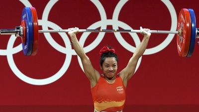India's Mirabai Chanu during her successful attempt at the Clean and Jerk event of Weightlifting in Tokyo. She won the silver medal in women's 49 kg category. (PTI) India's Mirabai Chanu during her successful attempt at the Clean and Jerk event of Weightlifting in Tokyo. She won the silver medal in women's 49 kg category. (PTI)