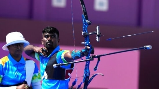 India's Pravin Jadhav, right, releases the arrow flanked by his teammate Deepika Kumari during the mixed team event at the 2020 Summer Olympics, Saturday, July 24, 2021, in Tokyo, Japan. (AP Photo/Alessandra Tarantino)(AP)