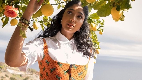 Maitreya casually plucked lemons as she posed in a white shirt over which she wore an orange crop top and matching skirt. (Instagram)