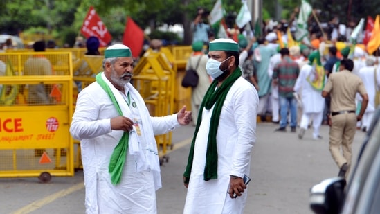 Bharatiya Kisan Union leader Rakesh Tikait interacts with a farmer at 'Kisan Sansad' at Jantar Mantar in New Delhi on Thursday.(ANI Photo)