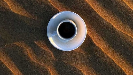 This photo of a cup of coffee placed on patterned sand has been photographed by Amish Jain.(Amish Jain)