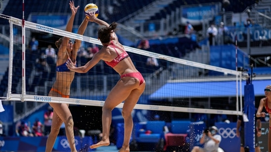 Katja Stam, of the Netherlands, blocks against Melissa Humana-Paredes, of Canada, during a women's beach volleyball match at the 2020 Summer Olympics, Saturday, July 24, 2021, in Tokyo, Japan. (AP Photo/Petros Giannakouris)(AP)