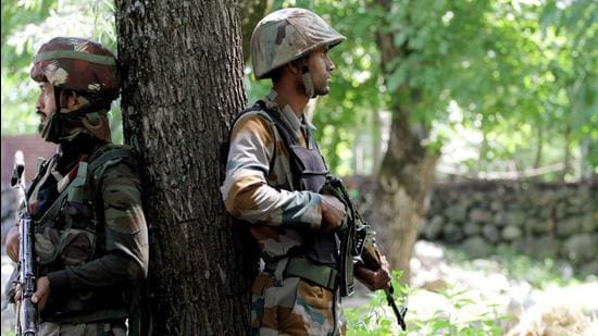 Jammu and Kashmir, July 24 (ANI): Army personnel take position during an encounter at Shokbaba forest, in Bandipora on Saturday. (ANI)