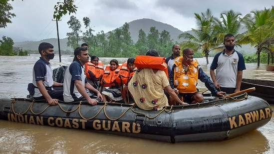 Indian Coast Guard (ICG) officers and Karnataka disaster response team during a rescue operation at a flooded area after heavy rain in Uttara Kannada district. (Via @IndiaCoastGuard on Twitter)