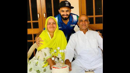 Amit with his parents. Amit with his parents.