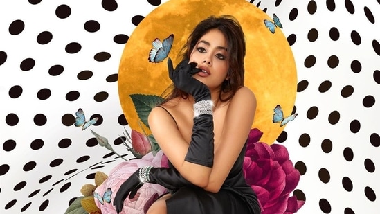 Janhvi Kapoor poses in a thigh-high slit gown and opera gloves.