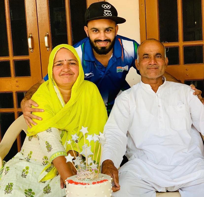Amit with his parents. Amit with his parents.