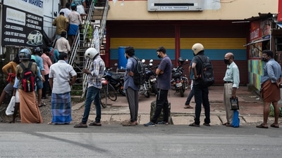 People wearing masks as a precaution against Covid-19 queue up maintaining physical distance to buy liquor in Kochi, Kerala (AP file photo) People wearing masks as a precaution against Covid-19 queue up maintaining physical distance to buy liquor in Kochi, Kerala (AP file photo)
