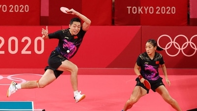 Tokyo 2020 Olympics - Table Tennis - Mixed Doubles - Semifinal - Tokyo Metropolitan Gymnasium - Tokyo, Japan - July 25, 2021.  Xu Xin of China and Liu Shiwen of China in action against Emmanuel Lebesson of France and Jia Nan Yuan of France REUTERS/Thomas Peter (REUTERS)