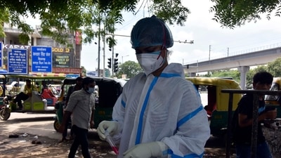 New Delhi, India - July 25, 2021: A health worker takes a swab sample for Covid-19 test, near Chattarpur Metro Station, in New Delhi. (Sanjeev Verma/HT PHOTO)