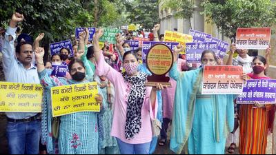 Contractual employees during a protest in Amritsar on Sunday. Contractual employees during a protest in Amritsar on Sunday.