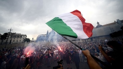 A protester holds an Italian flag as he takes part in a demonstration in Piazza del Popolo in Rome. (AFP) A protester holds an Italian flag as he takes part in a demonstration in Piazza del Popolo in Rome. (AFP)
