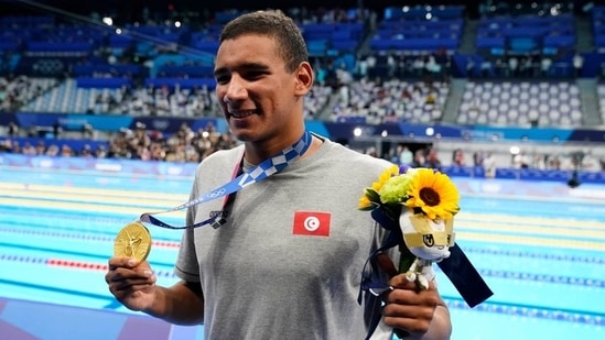 Jul 25, 2021; Tokyo, Japan; Ahmed Hafnaoui (TUN) celebrates with his gold medal during the medals ceremony for the men's 400m freestyle during the Tokyo 2020 Olympic Summer Games at Tokyo Aquatics Centre. Mandatory Credit: Rob Schumacher-USA TODAY Network(USA TODAY Sports)