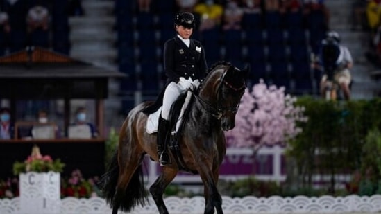 Germany's Dorothee Schneider, riding Showtime FRH, competes during the dressage Grand Prix competition at Equestrian Park during the 2020 Summer Olympics, Sunday, July 25, 2021, in Tokyo, Japan. (AP Photo/Carolyn Kaster)(AP)