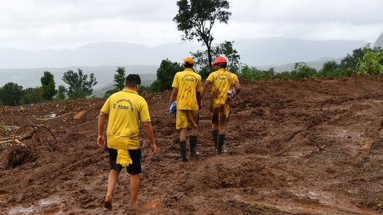 Target Disaster Response Force (TDRF) personnel search for victims at the site of a landslide at Taliye, about 22 km from Mahad city on July 24 as the death toll from heavy monsoon rains climbed to 76, with nearly 90,000 others evacuated in Maharashtra. (INDRANIL MUKHERJEE/AFP)
