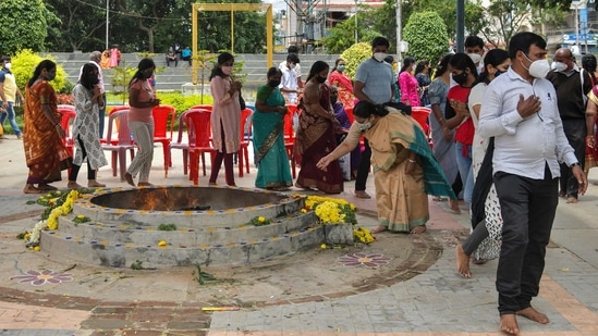 Para penyembah Bhagwan Sai Baba memanjatkan doa ke api suci selama perayaan Guru Purnima di Kuil Sai Baba di Bangalore. (Manjunath Kiran/AFP)