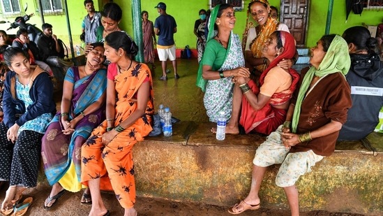 Villagers console a woman who lost a relative following a landslide at Taliye. (INDRANIL MUKHERJEE/AFP)