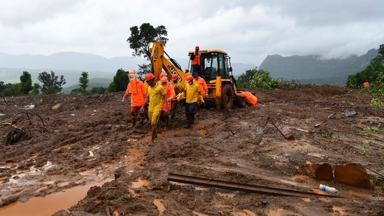 Target Disaster Response Force (TDRF) personnel carry the body of a victim at the site of a landslide at Taliye. (INDRANIL MUKHERJEE/AFP)