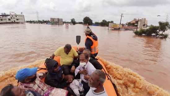 People stranded in flood waters are rescued Kolhapur inMaharashtra on July 24. Officials say landslides and flooding triggered by heavy monsoon rain have killed more than 100 people in western India. More than 1,000 people trapped by floodwaters have been rescued. (AP)