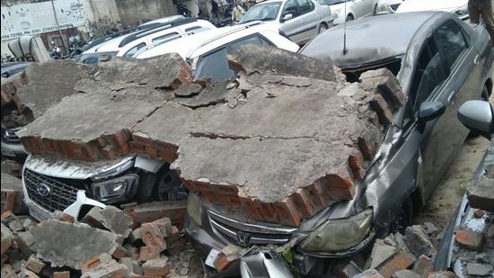 Cars crushed beneath the rubble at the ‘Books Market’ parking lot in Ludhiana on Sunday. (HT PHOTO)