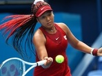 Naomi Osaka of Japan in action during her second round match against Viktorija Golubic of Switzerland at the Tokyo Olympics.