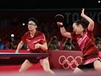 Japan's Jun Mizutani (L) and Mima Ito (R) compete against China's Xu Xin and Liu Shiwen in their mixed doubles table tennis final match at the Tokyo 2020 Olympic Games