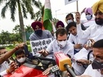 Congress leader Rahul Gandhi on a tractor outside the Parliament, in support of farmers' agitation against Centre's farm laws, in New Delhi on Monday, July 26. (PTI)
