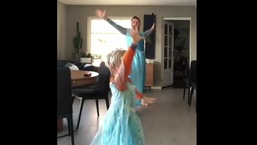 The image shows the dad dancing with his son to a Frozen song.