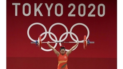 Indian weightlifter Saikhom Mirabai Chanu reacts after a successful attempt at Snatch in the women's 49kg event, in Tokyo, on July 24. Chanu wrote history for India with the first medal on the first day on Tokyo Olympics 2020. She won the silver in 49kg women’s weightlifting with a combined total of 202kg. It marked the first time that India won a medal on the opening day of an Olympics. (Gurinder Osan / PTI) Indian weightlifter Saikhom Mirabai Chanu reacts after a successful attempt at Snatch in the women's 49kg event, in Tokyo, on July 24. Chanu wrote history for India with the first medal on the first day on Tokyo Olympics 2020. She won the silver in 49kg women’s weightlifting with a combined total of 202kg. It marked the first time that India won a medal on the opening day of an Olympics. (Gurinder Osan / PTI)