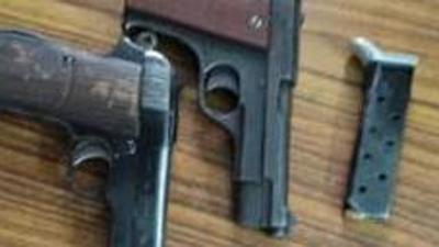 Seven pistols of .32 bore and four cartridges from the accused. (HT file)
