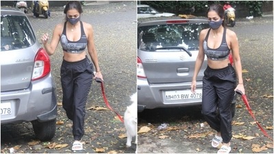 Malaika teamed her top with a pair of black joggers, white sliders, and a black face mask. She styled her street-style look by tying her locks in a loose ponytail, flaunting her natural glow and wearing a dainty gold chain. (Varinder Chawla) Malaika teamed her top with a pair of black joggers, white sliders, and a black face mask. She styled her street-style look by tying her locks in a loose ponytail, flaunting her natural glow and wearing a dainty gold chain. (Varinder Chawla)