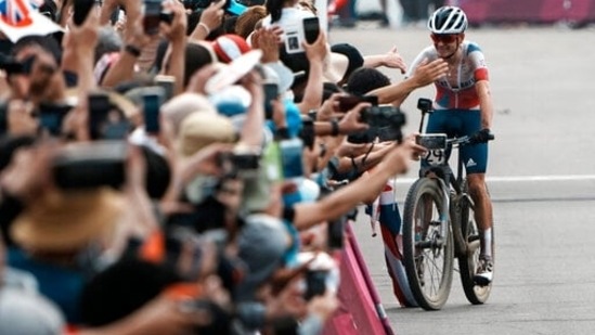 Thomas Pidcock of Great Britain is greeted after winning the gold medal during the men's cross country mountain bike competition at the 2020 Summer Olympics, Monday, July 26, 2021, in Izu, Japan. (AP Photo/Thibault Camus)(AP)