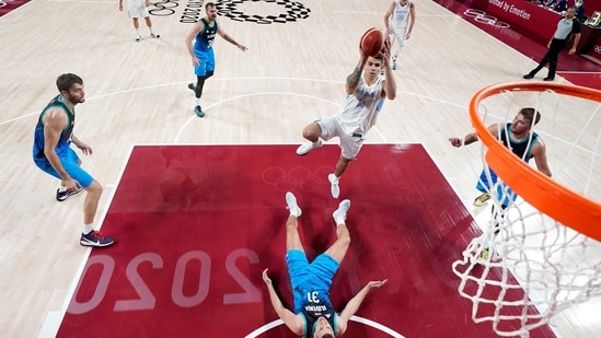 Argentina's Gabriel Deck shoots over Slovenia's Vlatko Cancar (31) during a men's basketball preliminary round game at the 2020 Summer Olympics, Monday, July 26, 2021, in Saitama, Japan. (Charlie Neibergall/Pool Photo via AP)(AP)