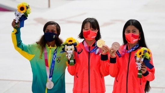 From left, silver medalist Rayssa Leal of Brazil, gold medalist Momiji Nishiya of Japan, center, and bronze medalist Funa Nakayama of Japan show their medals won in the women's street skateboarding finals at the 2020 Summer Olympics, Monday, July 26, 2021, in Tokyo, Japan. (AP Photo/Ben Curtis)(AP)