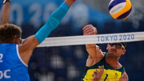 Christopher McHugh, right, of Australia, tries to get a shot past the defense of Konstantin Semenov, of the Russian Olympic Committee, during a men's beach volleyball match at the 2020 Summer Olympics, Monday, July 26, 2021, in Tokyo, Japan. (AP Photo/Petros Giannakouris)(AP)