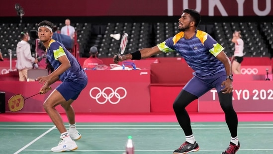 India's Satwiksairaj and Chirag Shetty play against Indonesia's Marcus Gideon and Kevin Zanjaya Sukamuljo during their men's doubles group play stage badminton match at the 2020 Summer Olympics, Monday, July 26, 2021, in Tokyo, Japan. (AP Photo/Dita Alangkara)(AP)