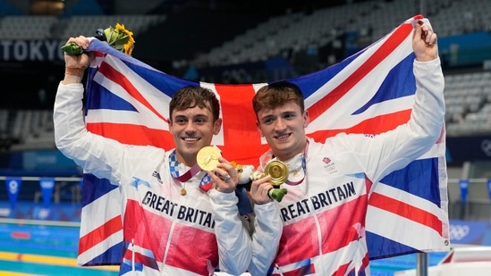 Tokyo: Thomas Daley and Matty Lee of Britain pose for a photo after winning gold medals during the men's synchronized 10m platform diving final at the Tokyo Aquatics Centre at the 2020 Summer Olympics, Monday, July 26, 2021, in Tokyo, Japan.AP/PTI(AP07_26_2021_000147A)(AP)
