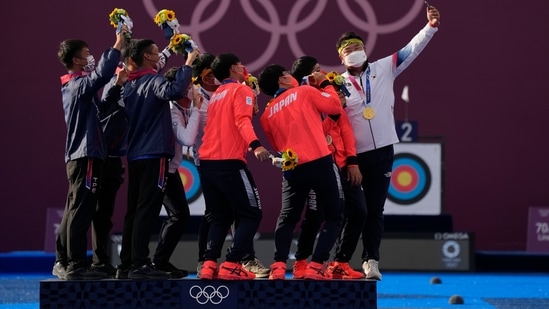Medalists of Taiwan's team, second placed, Japan's team, third placed, and South Korea's team, first placed, take a selfie at the end of the medal ceremony of the men's team finals at the 2020 Summer Olympics, Monday, July 26, 2021, in Tokyo, Japan. (AP Photo/Alessandra Tarantino)(AP)