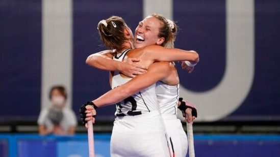 Germany's Nike Lorenz, right, celebrates scoring on India goalkeeper Savita with teammate Charlotte Stapenhorst (12) during a women's field hockey match at the 2020 Summer Olympics, Monday, July 26, 2021, in Tokyo, Japan. (AP Photo/John Minchillo)(AP)