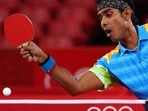Sharath Kamal Achanta of India in action against Ma Long of China in round 3 of men's singles table tennis in Tokyo Olympics